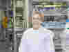 An image of a smiling Professor Ros Eeles, looking directly at the camera, wearing an ICR labcoat in a lab